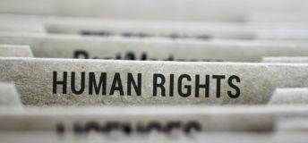 Photo of filing cabinet dividers with a focus on the human rights tab.