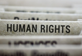 Photo of filing cabinet dividers with a focus on the human rights tab.