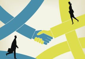 In brief: Double impact hire at M&G Illustration of two hands shaking with two business people walking by. Source - Getty