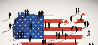 Silhouettes of people standing on the US flag.