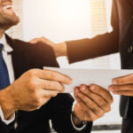 close up hand of employee receive bonus from manager