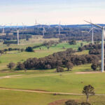 Aerial drone view of an array of large wind turbines at Biala and Gullen Range Wind Farm, Bannister in the Southern Tablelands region of New South Wales, Australia on a sunny day