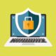 An illustration of a laptop and a shield on a green background