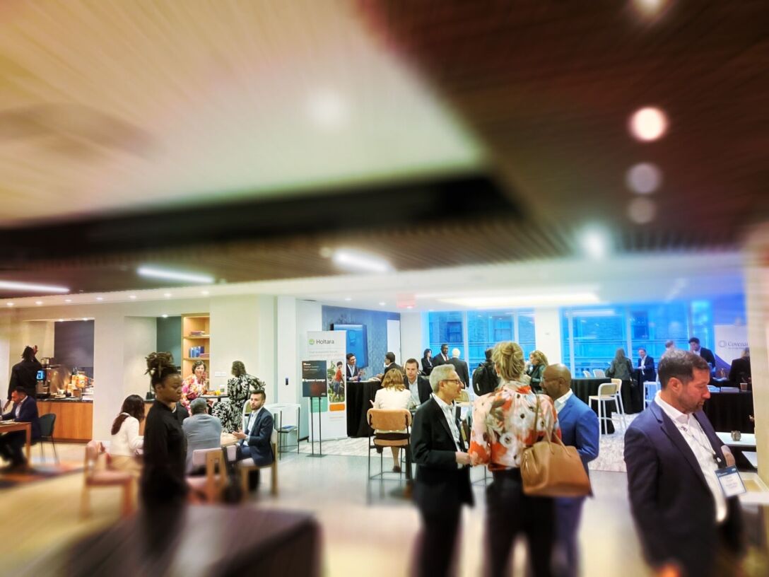 Conference attendees walking through event hall.