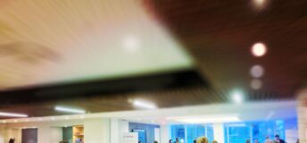 Conference attendees walking through event hall.