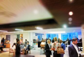 Conference attendees walking through event hall.